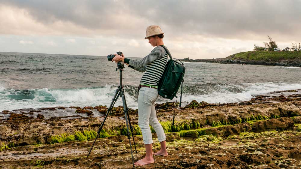 FLYING 'OKOLE Chelsea Kohl taking wave photos at Ho'okipa Maui on the About Design Solutions page.